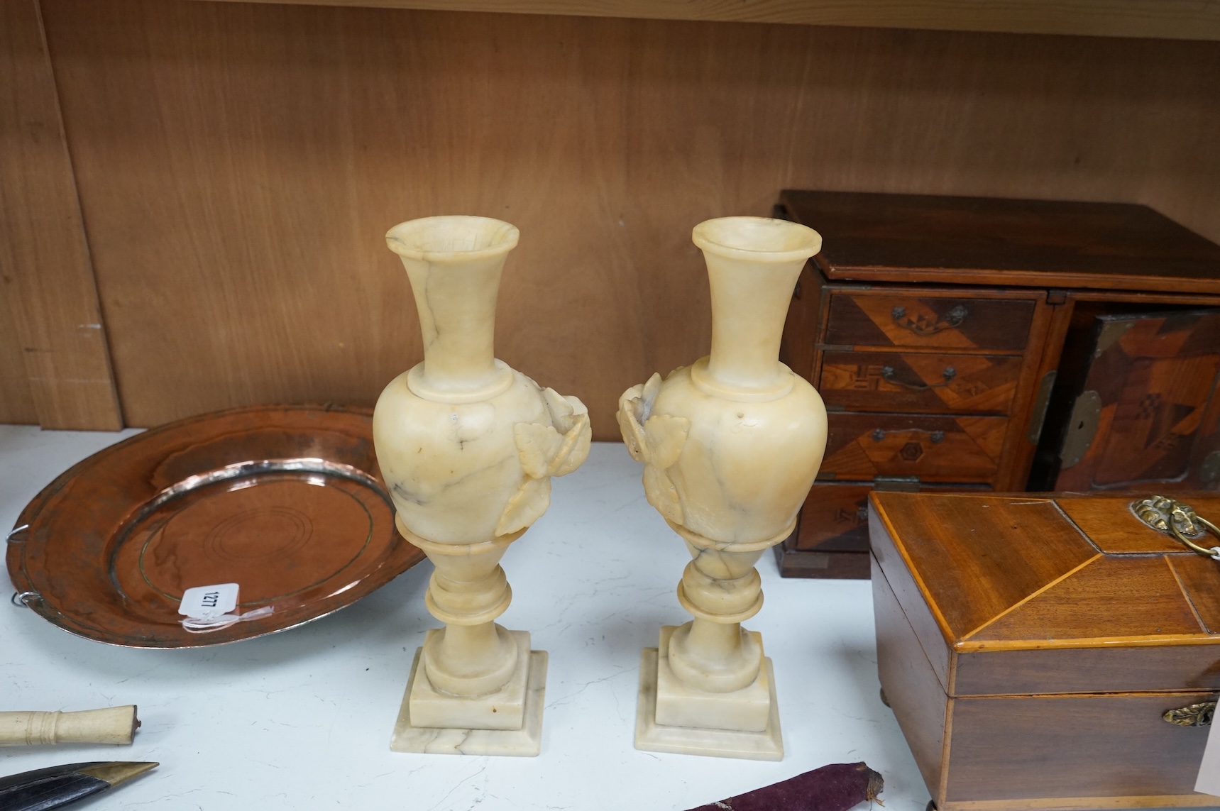 A pair of carved alabaster vases, 32cm high.